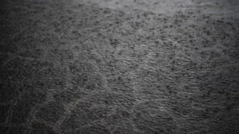 Heavy rain falls on a stone pavement during a violent thunderstorm Видео 154137558