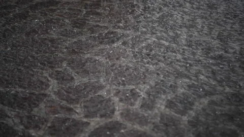Heavy rain falls on a stone pavement during a violent thunderstorm Video stock 154137682