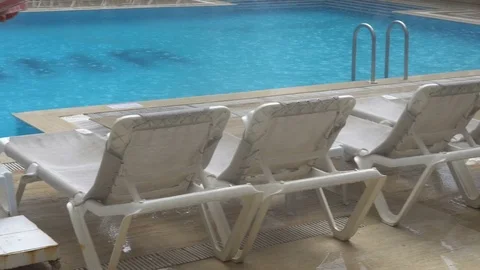 Heavy rain falls into a swimming pool. Not season, dirty abandoned pool Stock Footage 81990939