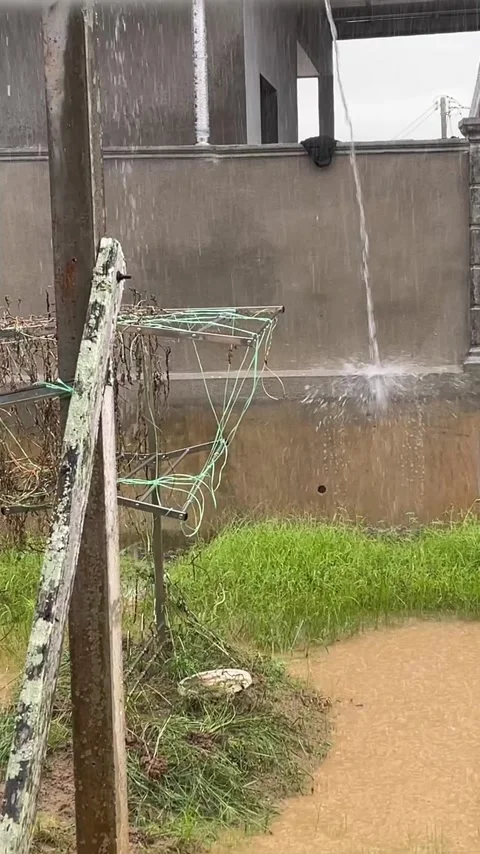 Heavy Rain Flooding Vegetable Garden With Water Pouring From Roof Stock Footage 335344631