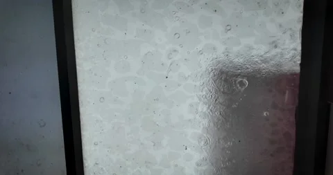 Heavy Rain Flowing Down a Window During Urban Storm in Mexico City Stock Footage 345521729