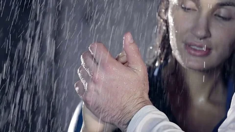 Heavy rain. the girl on the background of the face. the touch of two hands under Stock Footage