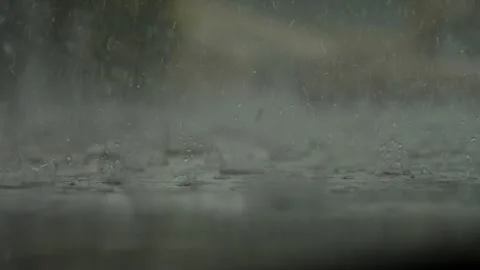 Heavy rain hitting the ground in close-up Stock Footage 321540094