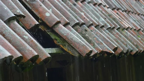 Heavy Rain Hitting Old House Roof With Missing Tiles during Thunderstorm Stock Footage 196897658