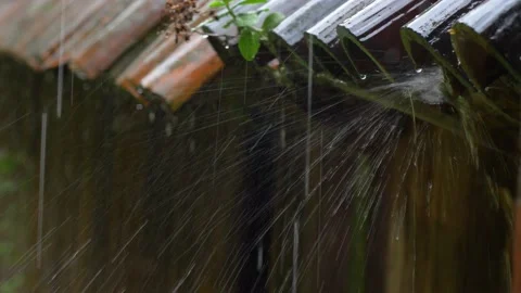 Heavy Rain Hitting Old House Roof Tiles during Thunderstorm Stock Footage 196897701