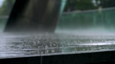 Heavy rain landing on pavement 스톡 동영상 49956231