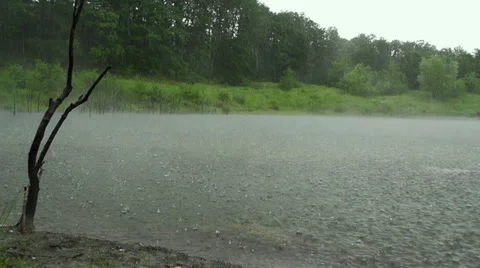 Heavy rain in the mountain lake in slow motion Stock Footage