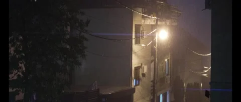 Heavy rain outside. Night, lightning, one lantern is lit. Storm in Belgrade Stock Footage 278454277