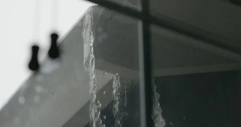 Heavy Rain Overflowing House Gutter Seen Through Window Stock Footage 332690321