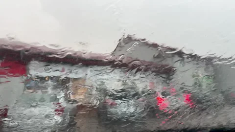 Heavy Rain Pouring On Car Windshield With Blurred City Traffic Video stock 341415425