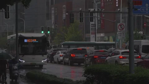 Heavy Rain Pouring Down on Busy City Street Traffic Stock Footage 339369490