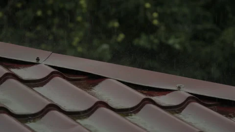 Heavy Rain Pouring Down on Red Metallic Roof of House. Gutter During Rainy Day Stock Footage 279468347