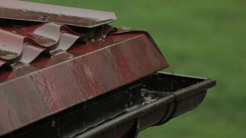 Heavy Rain Pouring Down on Red Metallic Roof of House. Gutter During Rainy .. Video stock 330124679