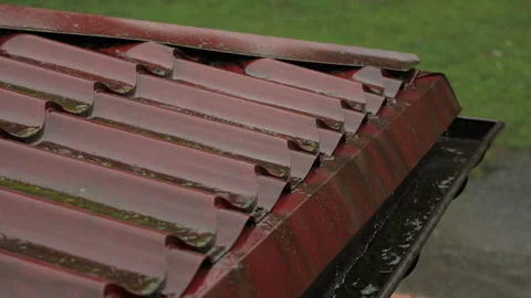 Heavy Rain Pouring Down on Red Metallic Roof of House. Gutter During Rainy .. Video stock 330124712