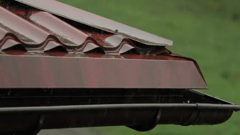 Heavy Rain Pouring Down on Red Metallic Roof of House. Gutter During Rainy .. Video stock 330124891
