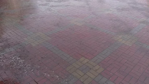 Heavy rain pouring on a tile pavement 库存影片 153630950