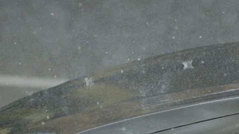 Heavy rain pours on car windshield in urban setting during late afternoon Stock Footage 345203274