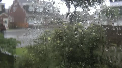 Heavy rain pours down glass of urban window during a thunderstorm Stock Footage 14717103