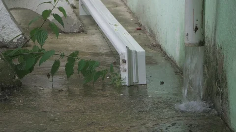 A heavy rain pours from the drainpipe Stock Footage 109393114