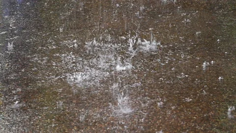 Heavy rain pummels and splashes concrete ground Stock Footage 137663826