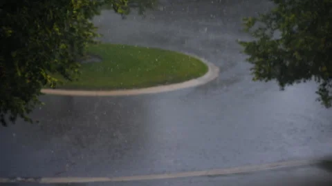 Heavy rain. Rain drops falls on the road at the street. View from above Stock Footage 314589817