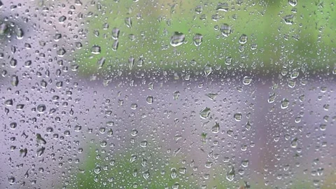 Heavy rain. Raindrops roll down the window pane during a windy thunderstorm. Video stock 136458891