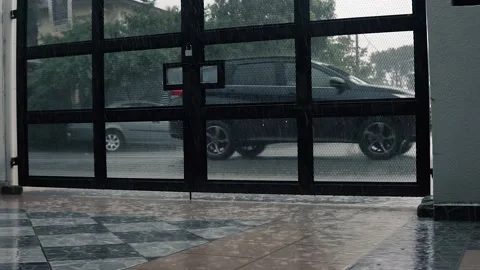 Heavy rain scene outside of the house with car passing through on the road. Stock Footage 143894306