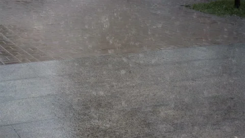 Heavy rain on the sidewalk as a background in 4K. Stock Footage 127346405