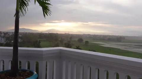 Heavy Rain at Sunset Looking over Rice Field in Vietnam Stock Footage 274965614