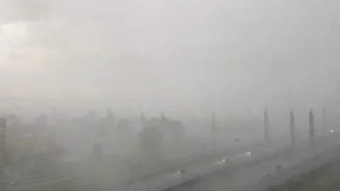 Heavy rain thunderstorm with wind gusts, hail in the city, poor visibility Stock Footage 133003913