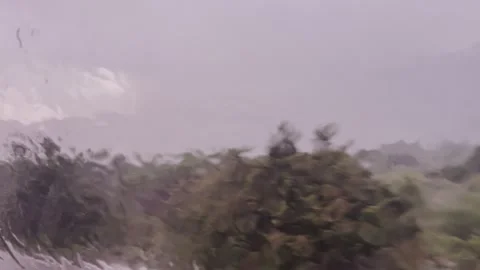 Heavy Rain View from Moving Car Window - Blurred Landscape 4K Stock Footage 340131625