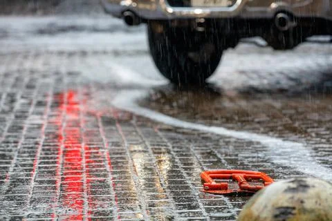 Heavy rain washes the flat rows of paving slabs in the parking lot, which ref Stock Photos