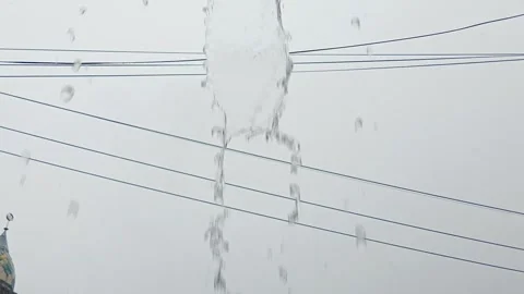 Heavy Rain Water Pouring Down Against Overcast Sky and Power Lines Stock Footage 334166827