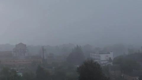 Heavy rain, wind and downpour on the background of buildings. City view. Cloudy  Stock Footage 252171589