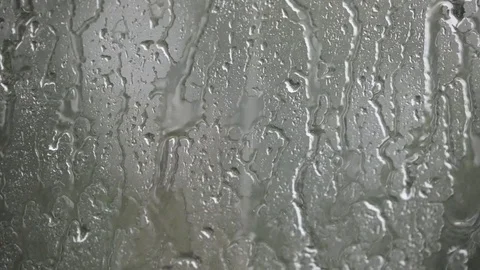 Heavy rain on window running water drops and splashes Stock Footage 80865306
