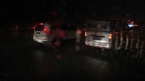 Heavy raindrops fall on car window on the highway Stock Footage 115894140