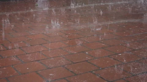 Heavy raindrops with hail fall on the paving slabs. Slow motion video. Stock-Footage 244523915