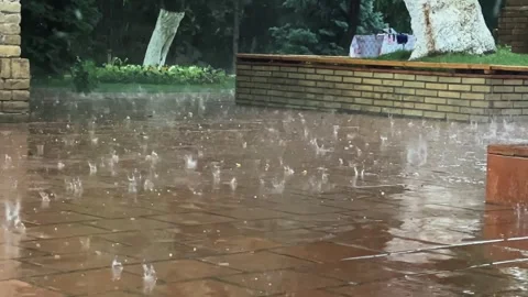 Heavy raindrops with hail fall on the paving slabs. Slow motion video. Stock-Footage 248790029