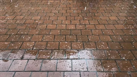 Heavy raindrops with hail fall on the paving slabs. Slow motion video. Stock-Footage 248790046