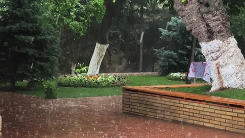Heavy raindrops with hail fall on the paving slabs. Slow motion video. Stock-Footage 249836932