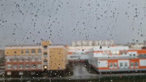 Heavy raindrops roll down the window pane. Video stock 214681691