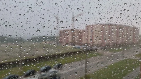 Heavy raindrops roll down the window pane. Stock Footage 217353191