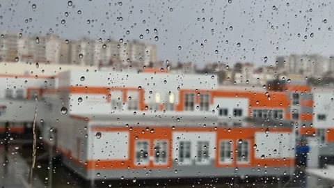 Heavy raindrops roll down the window pane. Stock Footage 217430377