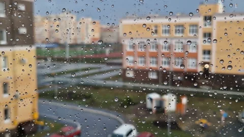 Heavy raindrops roll down the window pane. Stock Footage 217674529