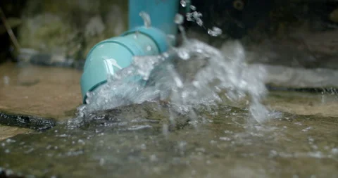 Heavy rainfall causes water to overflow from a roof drain pipe. Stock Footage 316487148