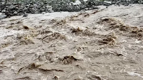 Heavy Rainfall Causing Flooded Stream with Muddy Water Vídeo Stock 339779271