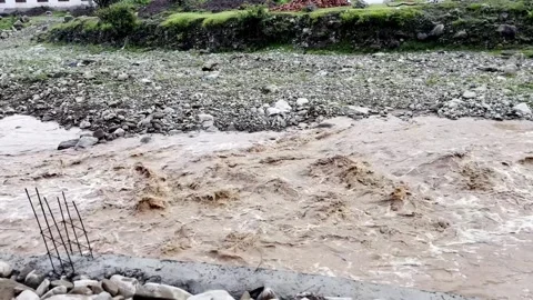 Heavy Rainfall Causing Flooded Stream with Muddy Water Vídeo Stock 339779275