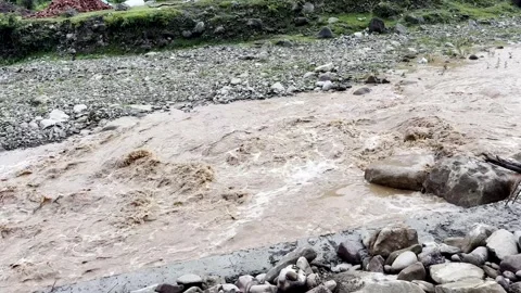 Heavy Rainfall Causing Flooded Stream with Muddy Water 動画素材 339779382