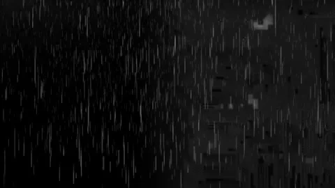 Heavy rainfall falling against a deep black background creating a dramatic Stock Footage 338996777