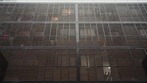 Heavy rainfall hitting a modern building facade during the monsoon season Video stock 346346067